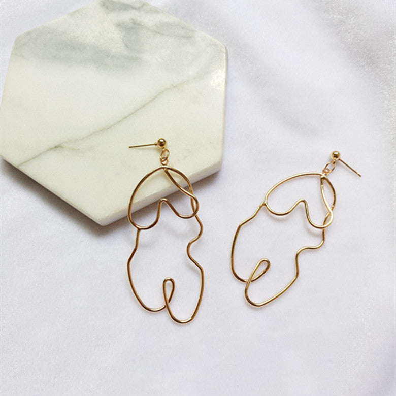 Boucles d'oreilles Twistées Oversize – Élégance audacieuse pour briller en toute confiance